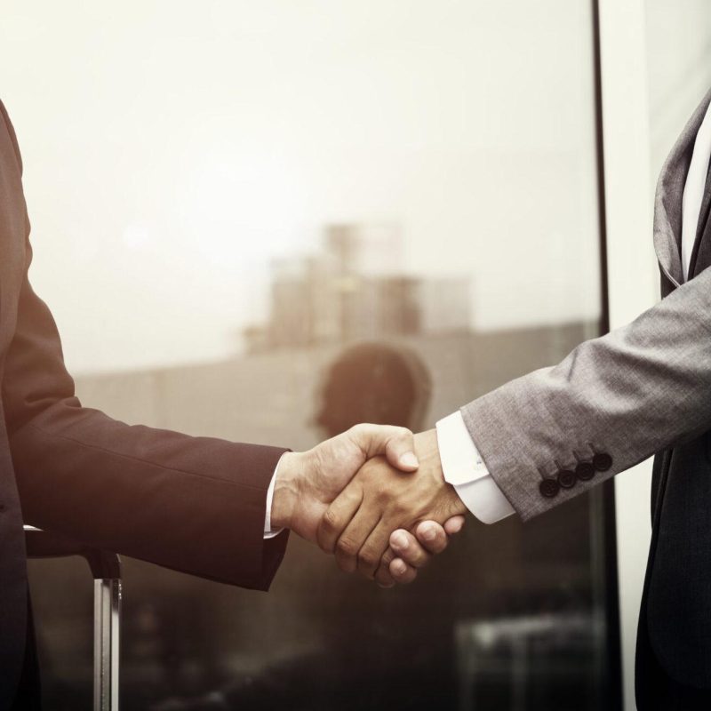 Corporate businessmen shaking hands